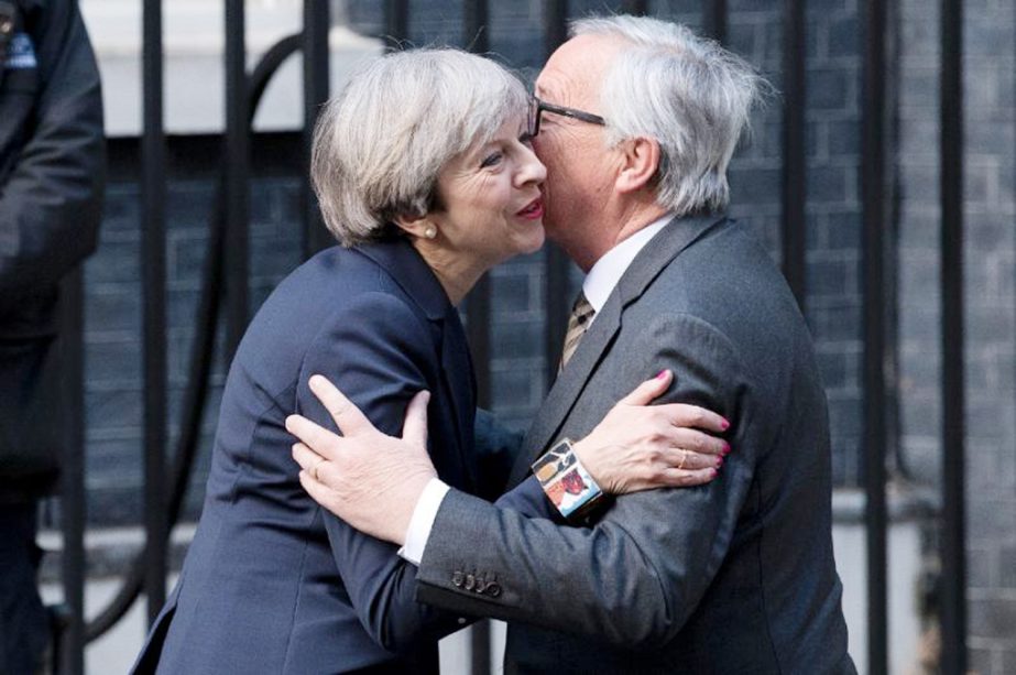 Kiss, off: European Commission President, Jean-Claude Juncker embraces British Prime Minister Theresa May outside 10 Downing Street in April.