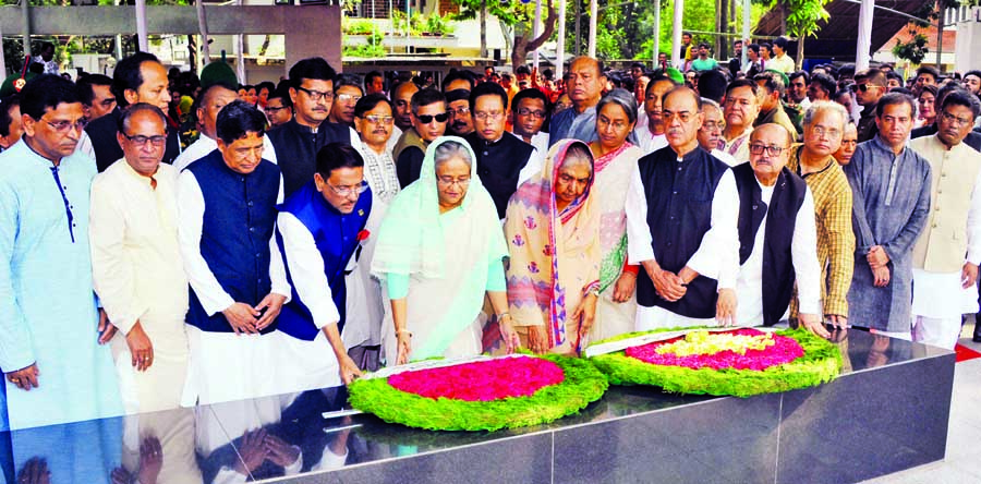 Prime Minister Sheikh Hasina placing wreaths at the portrait of Bangabandhu Sheikh Mujibur Rahman to commemorate the historic Six-point Demand Day at Dhanmondi with party's central leaders on Wednesday.