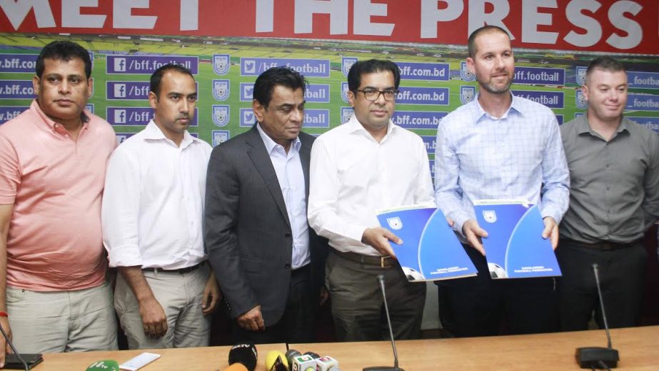 Vice-President of Bangladesh Football Federation (BFF) Kazi Nabil Ahmed and newly appointed Head Coach of Bangladesh National Football team Andrew Ord showing the agreement papers at the conference room of BFF House on Wednesday.