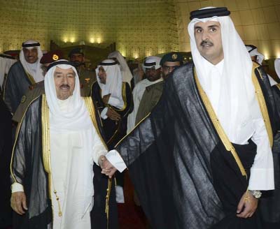 Kuwait's Emir Sheikh Sabah Al Ahmad Al Sabah, left, holds the hand of Qatar's Emir Sheikh Tamim bin Hamad Al Thani in Doha, Qatar. on Wednesday.