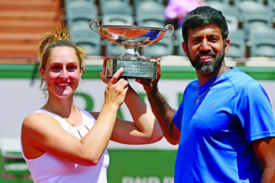 Canada's Gabriela Dabrowski and India's Rohan Bopanna hold the trophy as they celebrate winning their mixed doubles final match against Anna-Lena Groenefeld of Germany and Robert Farah of Colombia in two sets 2-6, 6-2 (12-10), of the French Open tennis