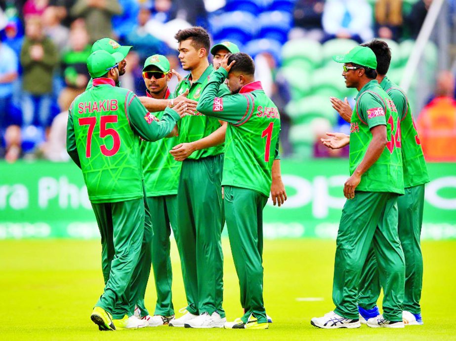 Taskin Ahmed is mobbed by his team-mates during the ICC Champions Trophy match against New Zealand in Cardiff, Wales on Friday.