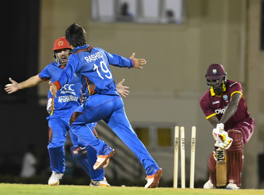 Rashid Khan goes through Jason Holder's defense during the 1st ODI between West Indies and Afghanistan at St Lucia on Saturday.