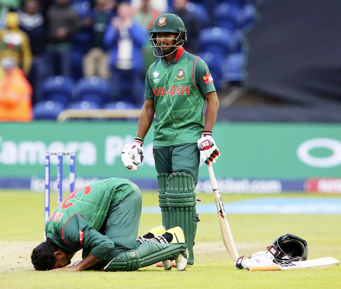 Bangladesh's Mahmudullah (L) celebrates reaching 100 during the ICC Champions Trophy match between New Zealand and Bangladesh in Cardiff on Friday. Bangladesh beat New Zealand by five wickets in their Champions Trophy Group A match.