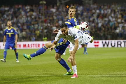 Bosnia's Edin Dzeko (right) and Greece's Kostas Manolas, fight for the ball during their World Cup Group H qualifying match at the Bilino Polje Stadium in Zenica on Friday.