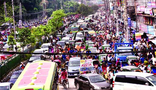 City experiences massive traffic gridlock from New Market area to Kalabagan as makeshift traders occupy the footpaths as well as cars being parked illegally on both sides of the busy road, causing sufferings to commuters and Eid shoppers. This photo was t