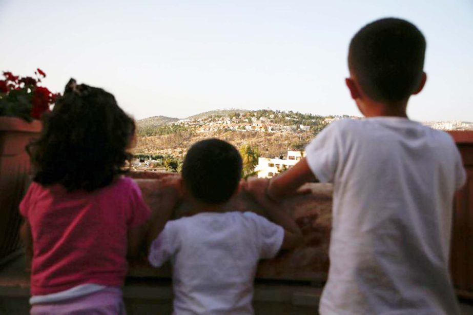 Children from the Palestinian village of Deir Ibzi in the Israeli-occupied West Bank look at the Jewish settlement of Dolev .