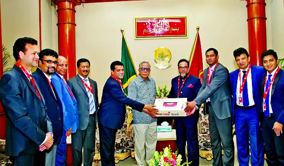 Mohammed Mahtabur Rahman (Nasir), Chairman of NRB Bank Limited, handing over token contribution for under privileged people of the Haor area to the President Md. Abdul Hamid, at a function held at Bangabhaban on Sunday. Md Mehmood Husain, Managing Directo