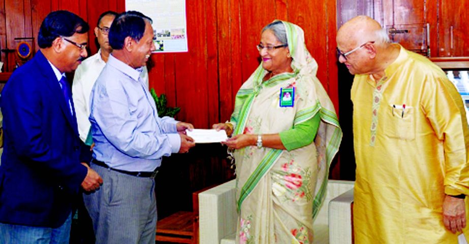 Monzur Hossain, Chairman and Md. Ataur Rahman Prodhan, Managing Director of Rupali Bank Limited, handing over a cheque to Prime Minister Sheikh Hasina for her Relief Fund on Monday. Finance Minister AMA Muhith was also present.