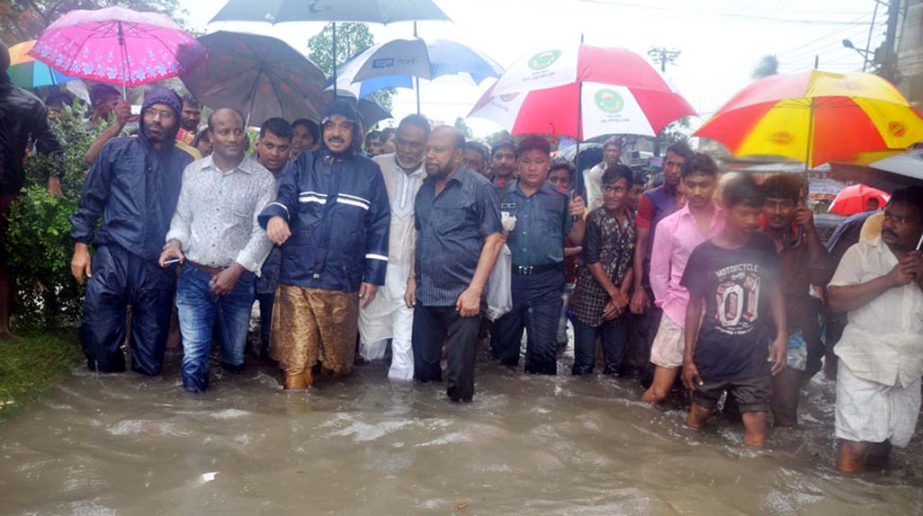CCC Mayor A J M Nasir Uddin visiting water-logging situation at Boro Pole area in Halisahar yesterday.