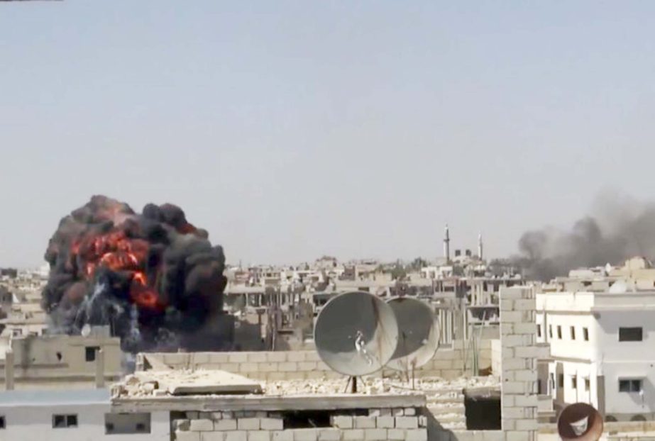 Smoke believed to be white phosphorus is seen in the sky during a strike on a neighbourhood of west Mosul on June.