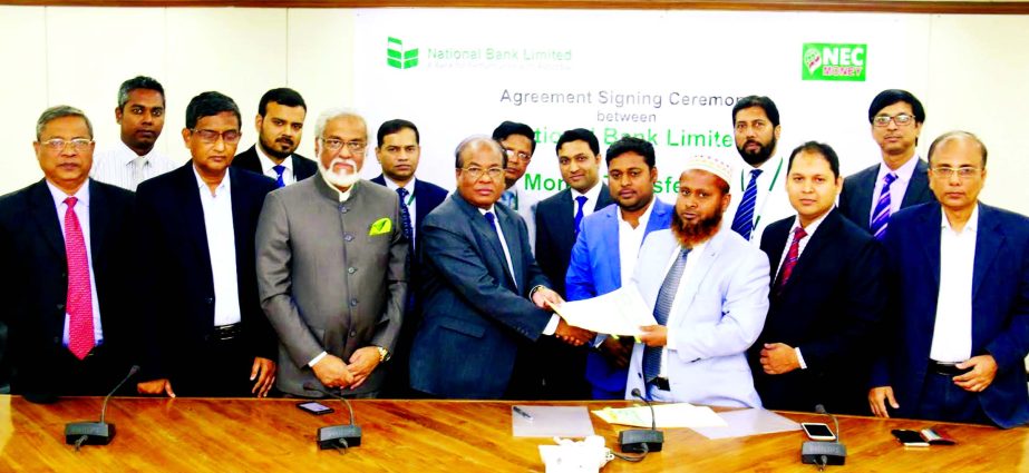 M.A. Wadud, AMD of National Bank Limited and Ikram Farazy, Managing Director and CEO of NEC Money Transfer Ltd. UK , sign an agreement at the bank's head office recently. DMDs of the bank Abdus Sobhan Khan, Shah Syed Abdul Bari, Md. Farid Uddin Ahmed and