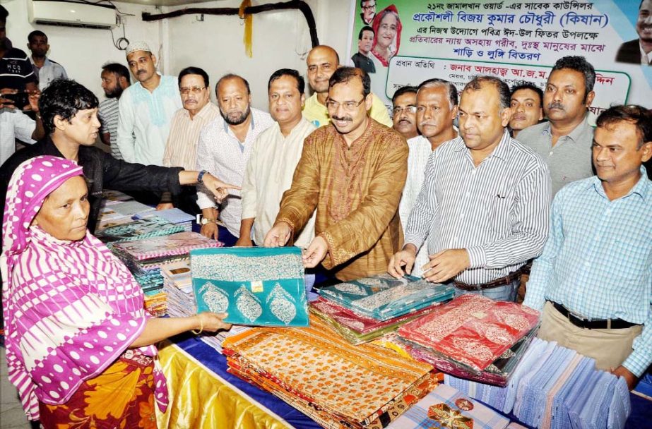 CCC Mayor A J M Nasir Uddin distributing Eid clothes among the poor and distressed people at Jamalkhan Ward on Tuesday.