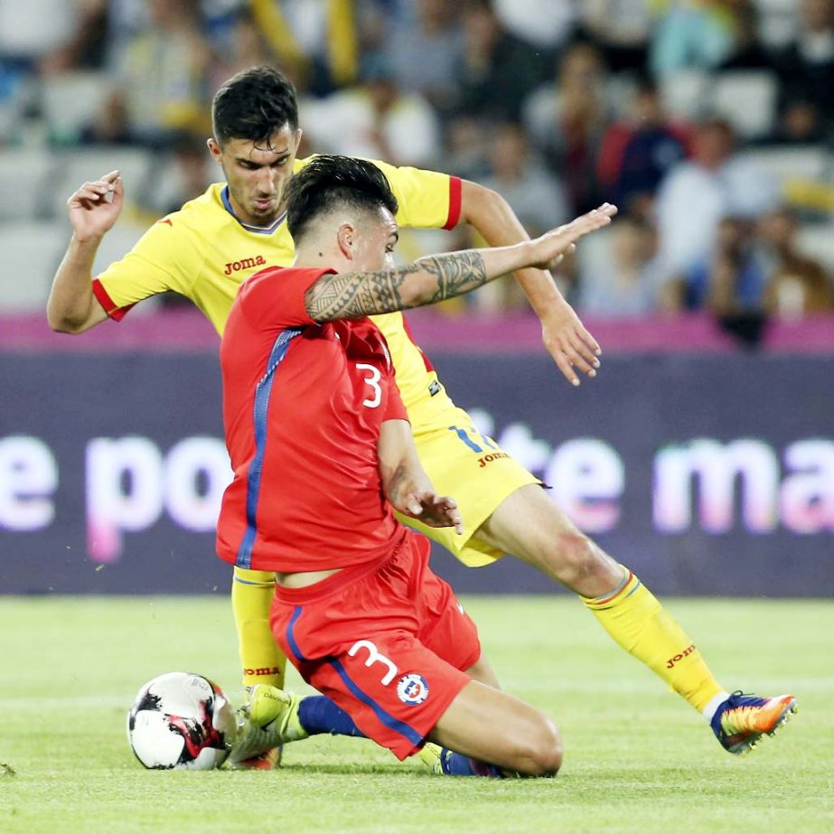 Chile's Enzo Roco (left) challenges for the ball with Romania's Andrei Ivan during the international friendly soccer match between Romania and Chile at the Cluj Arena stadium in Cluj, Romania on Tuesday.