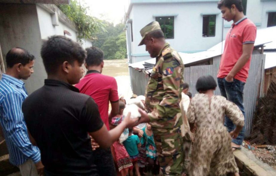 Army officials distributing relief goods among the landslide victims at Rangamati on Wednesday.