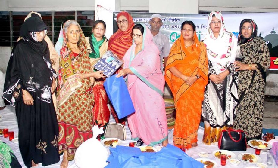 President of Chittagong city Mahila Awami League Hasina Mohiuddin distributing cash and clothes among the distressed people in the city yesterday.