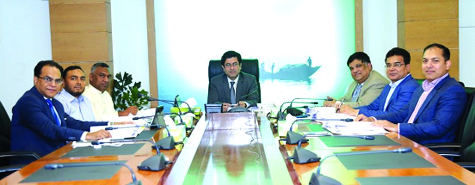Barrister Sheikh Fazle Noor Taposh MP, EC Chairman of Modhumoti Bank Limited, presiding over the 58th meeting at the banks head office in the city on Thursday. Md Shafiul Azam, Managing Director of the bank, Mohammad Ismail Hossain, Managing Director of S
