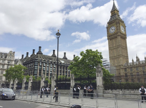 Police detain a man outside the House of Commons, London on Friday. Scotland Yard said the man â€“ aged in his 30s â€“ was arrested on suspicion of possessing a knife. there were no injuries. .