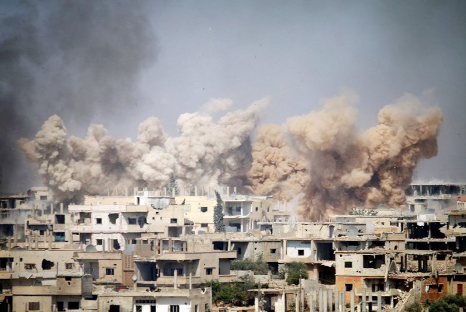 Smoke rises from buildings following a reported air strike on a rebel-held area in the southern Syrian city of Daraa