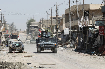 Iraqi forces, consisting of the Iraqi federal police and the elite Rapid Response Division, patrol in the Shifa neighbourhood, on the west bank of Mosul.