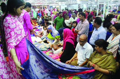 SYLHET: Buyers are busy in Eid shopping at Maha , a shopping mall in Sylhet city yesterday.