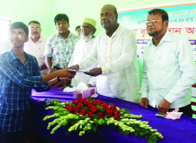 BHANGURA (Pabna): Alhaj Mokbul Hossain MP distributing scholarship among the meritorious children of poor families on behalf of PCD an NGO at Bhangura High School & College on Saturday. Among others, Md Shafiqul Islam, Executive Director of PCD, Aslam Al
