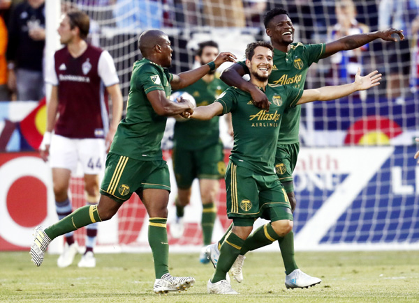 Portland Timbers midfielder Sebastian Blanco (center) celebrates after scoring a goal with midfielder Darlington Nagbe (left) and forward Dairon Asprilla against the Colorado Rapids in the first half of an MLS soccer match on Saturday.