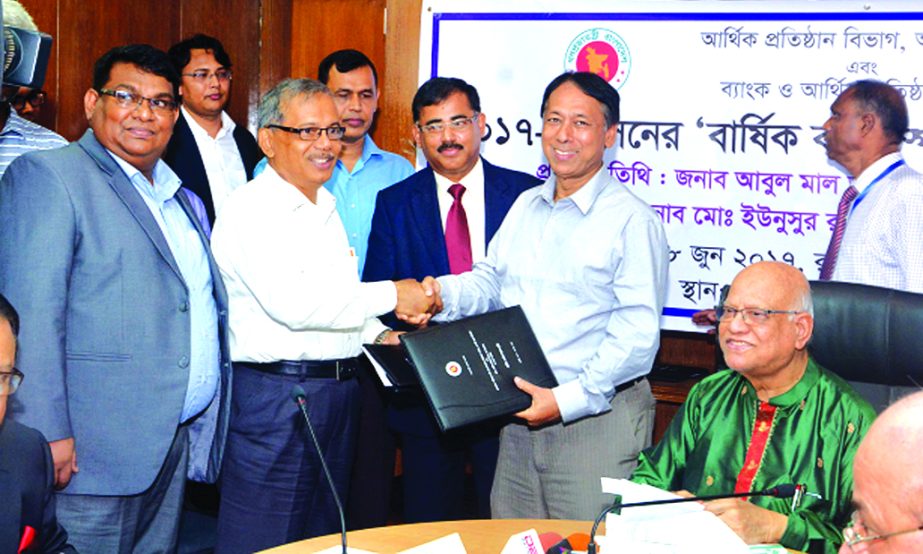 Md. Eunusur Rahman, Secretary of Financial Institutions Division and Monzur Hossain, Chairman of Rupali Bank Ltd, exchanging the Annual Performance Agreement (2017-18) signing documents at Finance Ministry on Sunday. Finance Minister Abul Maal A Muhith, M