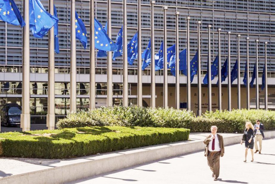 European Union flags fly at half staff in front of EU headquarters in Brussels on Monday.