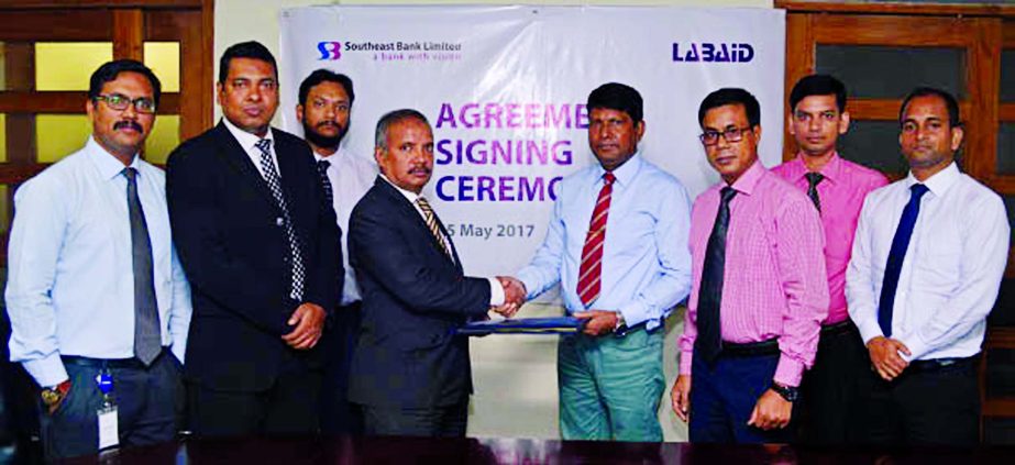 Md. Abdus Sabur Khan, Head of Cards of Southeast Bank Limited and (Dr.) Khan Md. Asadulla Hel Galib, Brig. Gen. (Retd.), Medical Director of LABAID Group, sign an agreement in the city recently. Under this deal, the bank's card holders can avail up to 15