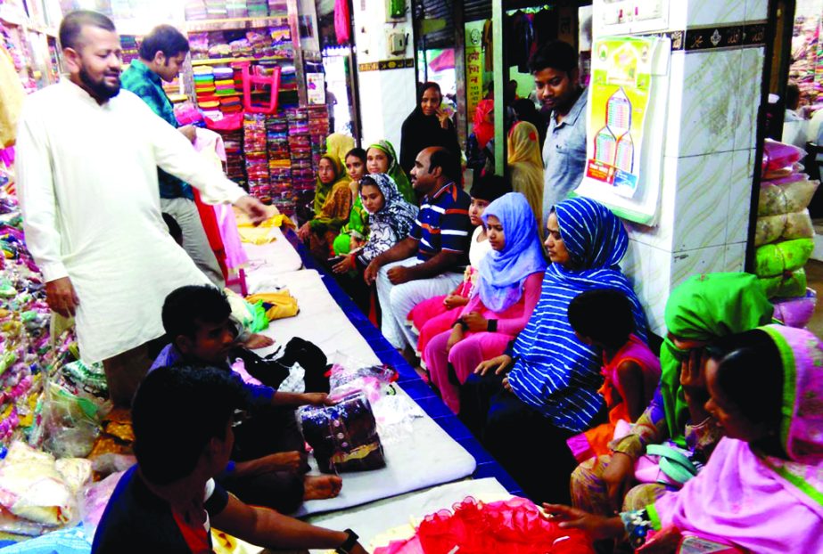 SAPAHAR (Naogaon): Both buyers and shop keepers are busy at a market in Sapahar Upazila in Eid shopping yesterday.