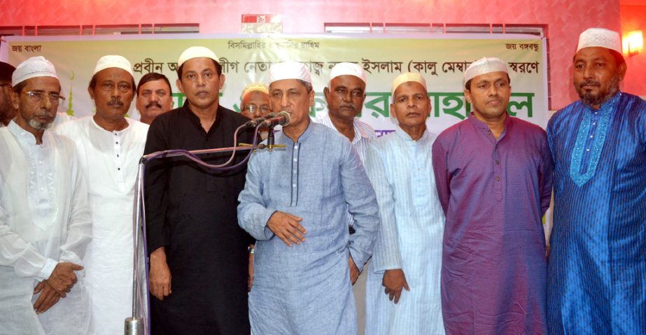 Chairman of Chittagong Development Authority (CDA) Abdus Salam distributing clothes and Iftar items among the poor in Boxirhat Ward organised by local Awami League on Tuesday.