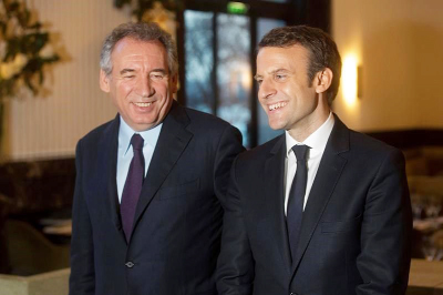 French centrist politician Francois Bayrou, left, and candidate for the 2017 French presidential election, Emmanuel Macron, pose for photographers after a meeting, in Paris.