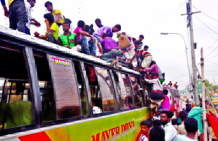 Home-bound passengers going to their respective destination getting on the roof of a bus to celebrate Eid with their near and dear ones. The snap was taken from the city's Gabtoli on Thursday.
