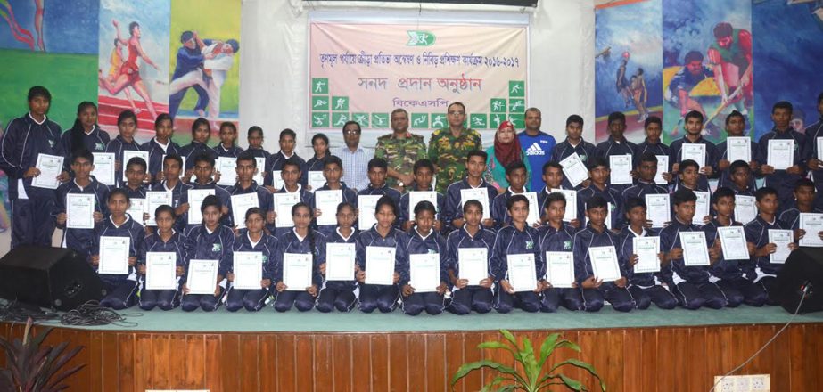 The participants of the intensive training camp of BKSP pose with certificates with the chief guest Director General of BKSP Brigadier General Md Shamsur Rahman and other officials of BKSP at the BKSP Ground in Savar on Thursday.