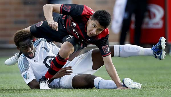 Minnesota United's Kevin Molino (bottom) and Portland Timbers' Marco Farfan (32) get tangled up during the first half of an MLS soccer match in Minneapolis on Wednesday.