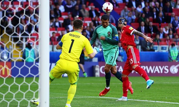 Cristiano Ronaldo heads the ball beyond Igor Akinfeev to score Portugal's winning goal after just eight minutes of the match .