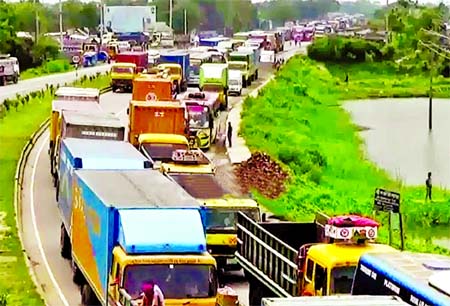 Hundreds of light to heavy vehicles got stuck at 13 km long tailback on Dhaka-Chittagong Highway causing immense sufferings to commuters and Eid home goers on Thursday.