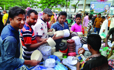 SYLHET: Men are selecting tupi in front of Qudart Ullah Jamay Mosque on Thursday.