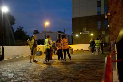 Camden council representatives talk as they help residents as they are evacuated from the Burnham residential tower block on the Chalcots Estate, in the borough of Camden, north London on Friday.