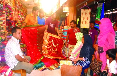 ISHWARDI (Pabna): Both buyers and sellers are busy at a market in Eid shopping at Ishwardi Upazila on Friday.