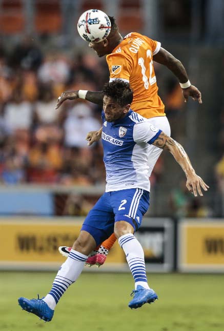 Houston Dynamo forward Romell Quioto (12) and FC Dallas defender Hernan Grana (2) go after the ball during the first half of an MLS soccer game in Houston on Friday.