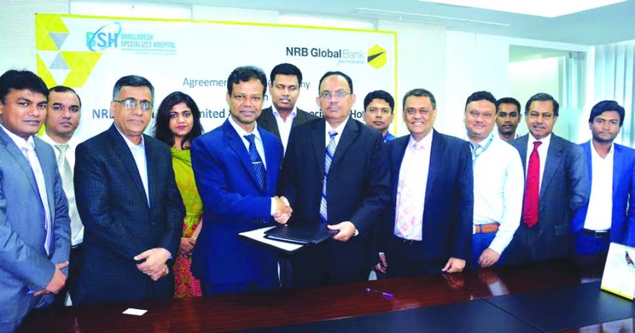 Mohammad Shamsul Islam, Deputy Managing Director of NRB Global Bank and Dr. Ahmed Zahid Hossain, Director (Operations), Bangladesh Specialized Hospital, sign an agreement at the bank's head office recently. Deputy Managing Director of the bank Kazi Mas