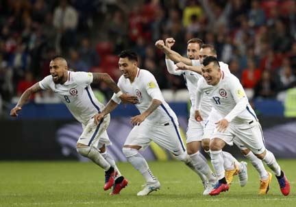 Chile players run celebrating after winning the Confederations Cup, semifinal soccer match between Portugal and Chile at the Kazan Arena, Russia on Wednesday.