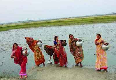 BAGERHAT: Women collecting drinking water from a pond in Morrelganj . This snap was taken yesterday.