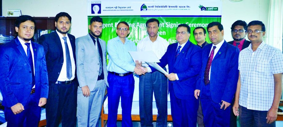 Ali Nahid Khan, Head of Agent & Mobile Banking Division of First Security Islami Bank Limited and Md. Nazmul Haque, Controller, Finance & Accounts Division of Bangladesh Rural Electrification Board (BREB) exchanging agreement singing documents at the bank
