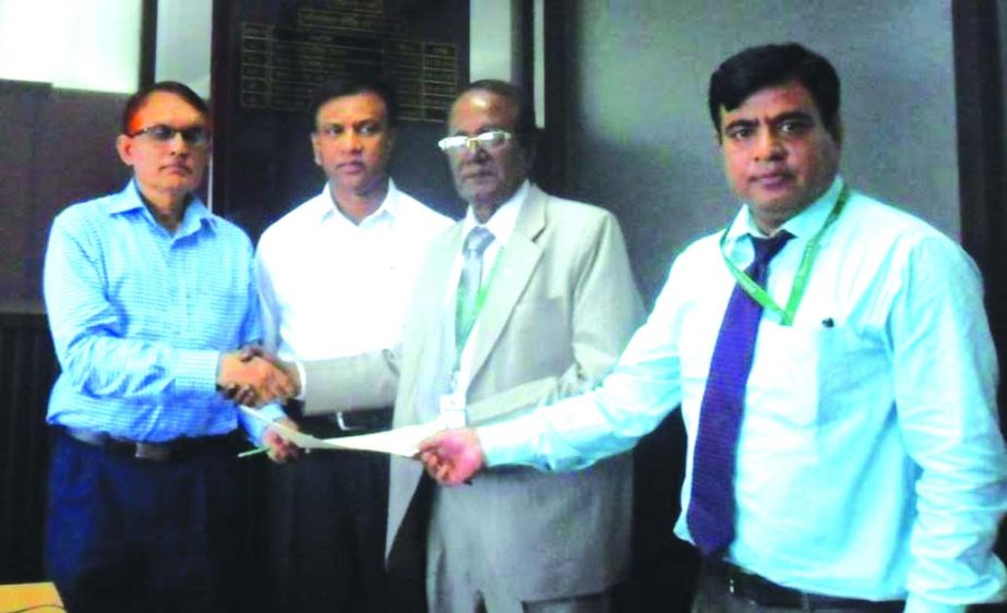 Hossain Patwary, Director (Finance), Bangladesh Rural Electrification Board and A.F. Jamal Uddin, Head of Agent Banking Division of Standard Bank Ltd, exchanging the signing documents on electric bill collection through the bank at the board head office r