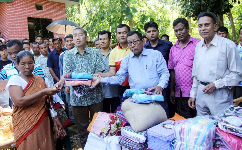 Abdul Wahab, Acting Chairman of Zilla Parishad distributing relief materials among the flash flood victims at Rangunia upazila on Wednesdayy.