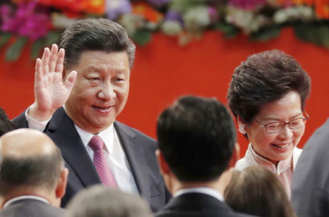 Chinese President Xi Jinping, left, and Hong Kong's new Chief Executive Carrie Lam leave after administering the oath for a five-year term in office at the Hong Kong Convention and Exhibition Center in Hong Kong on Saturday