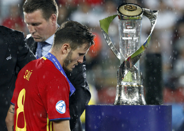 Spain's Saul Niguez (front) walks past the trophy during the winning ceremony after the Euro Under- 21 final soccer match between Germany and Spain in Krakow, Poland on Friday. Germany defeated Spain by 1-0.